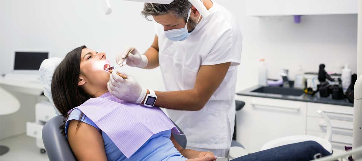 Dentist providing treatment at Whiteberry Dental Clinic